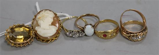 An 18ct gold and three stone diamond ring, four other rings (including two 18ct) and two brooches.